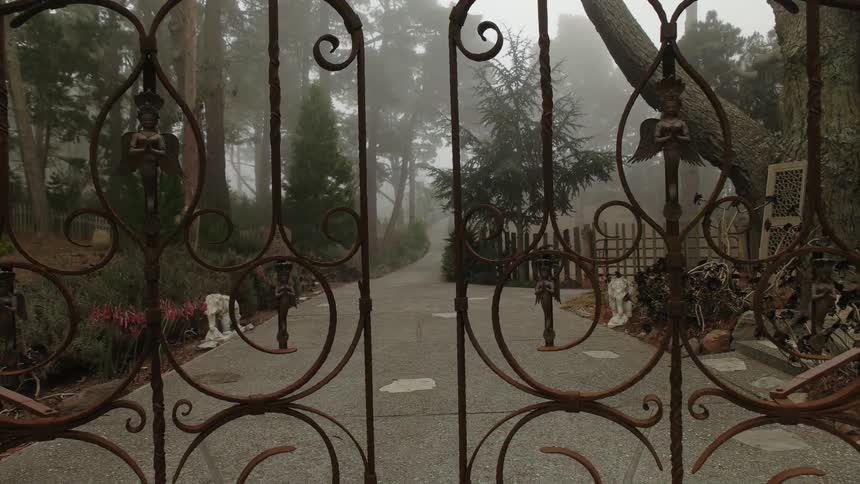 Iron gates open on a foggy day