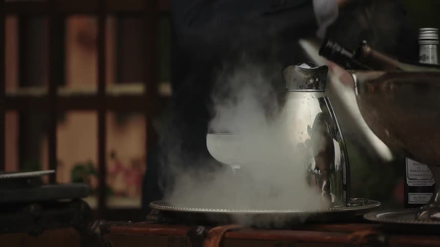 A bartender mixes drinks