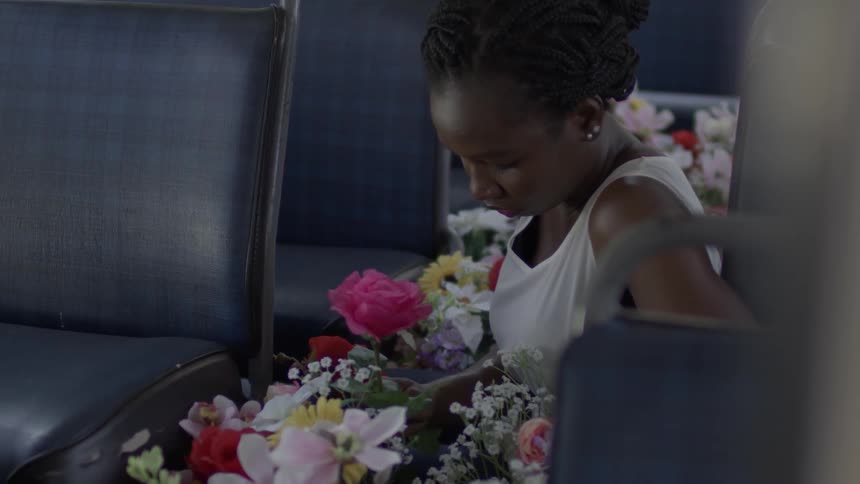 Woman sitting on a bus holds a bouquet of flowers