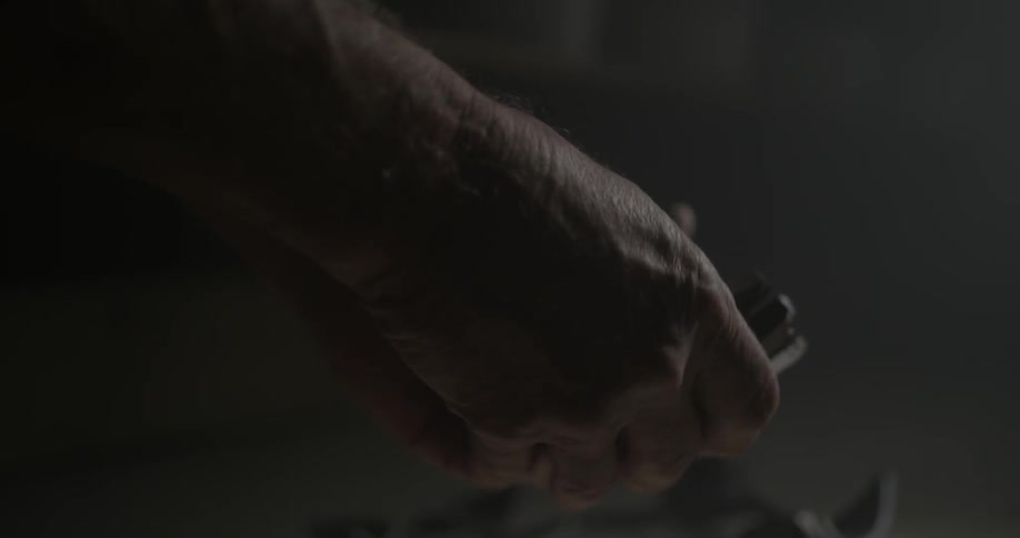A man is piecing together a broken pot