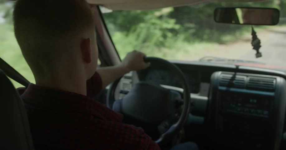 A man is driving a car