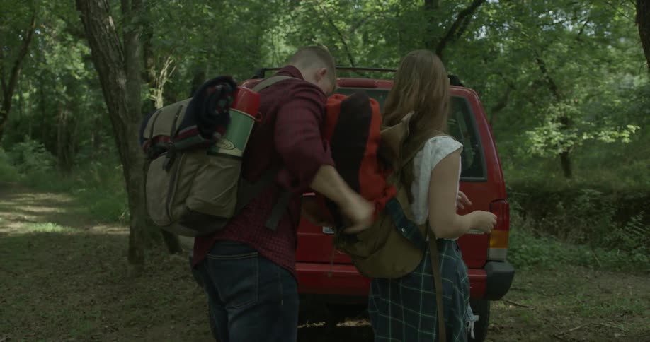 A man and women prepare to go camping