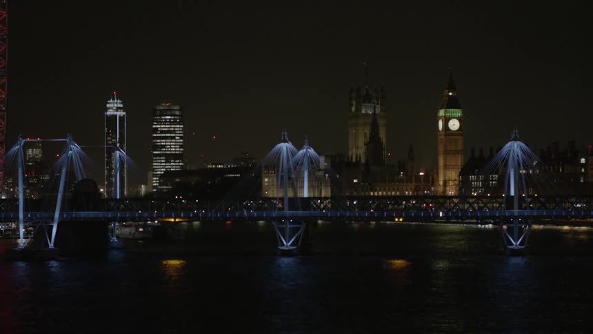 City lit up at night next to a river