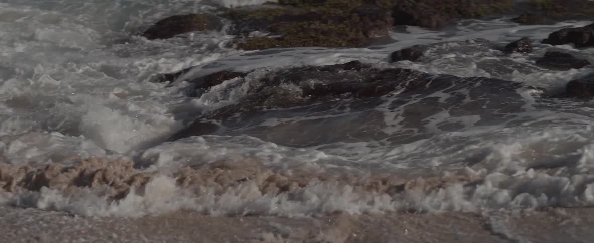 Waves are crashing ashore in slow motion