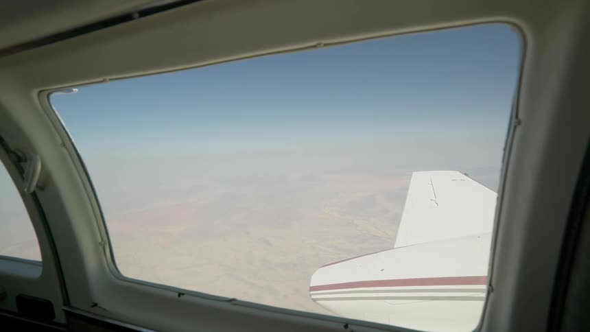 Outside of the plane window is all fog