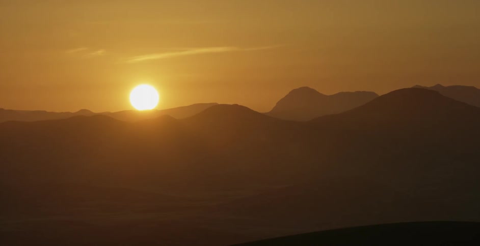 Sun sets over sandy hills in the desert
