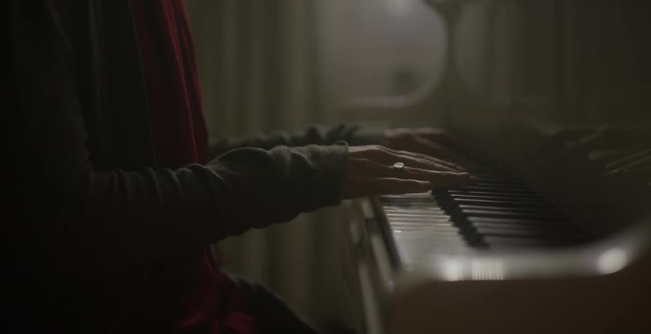 A person slowly plays the piano