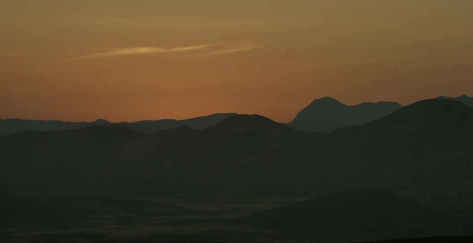 A skyline full of hills is being filmed at dawn