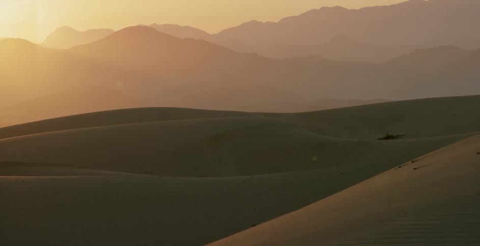 Sun shines over sand dunes in the desert