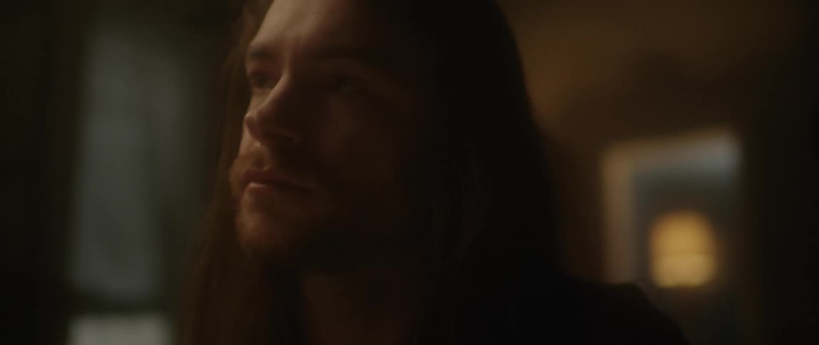 A man in a house is looking off screen