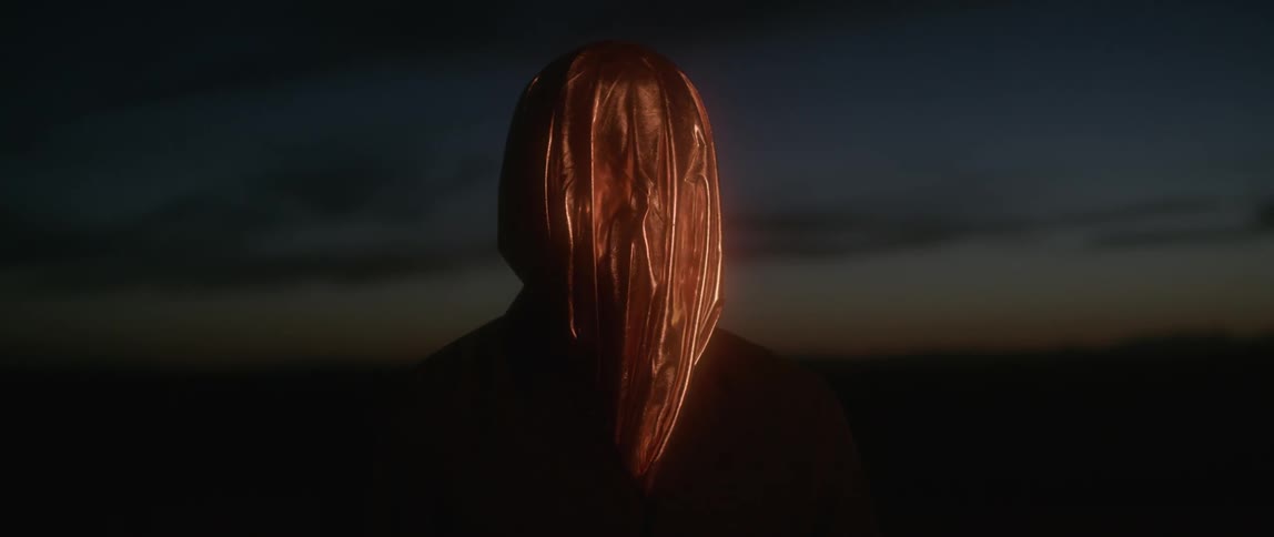A person is wearing a bag over his head