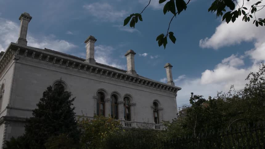 A large building has trees right up against the side