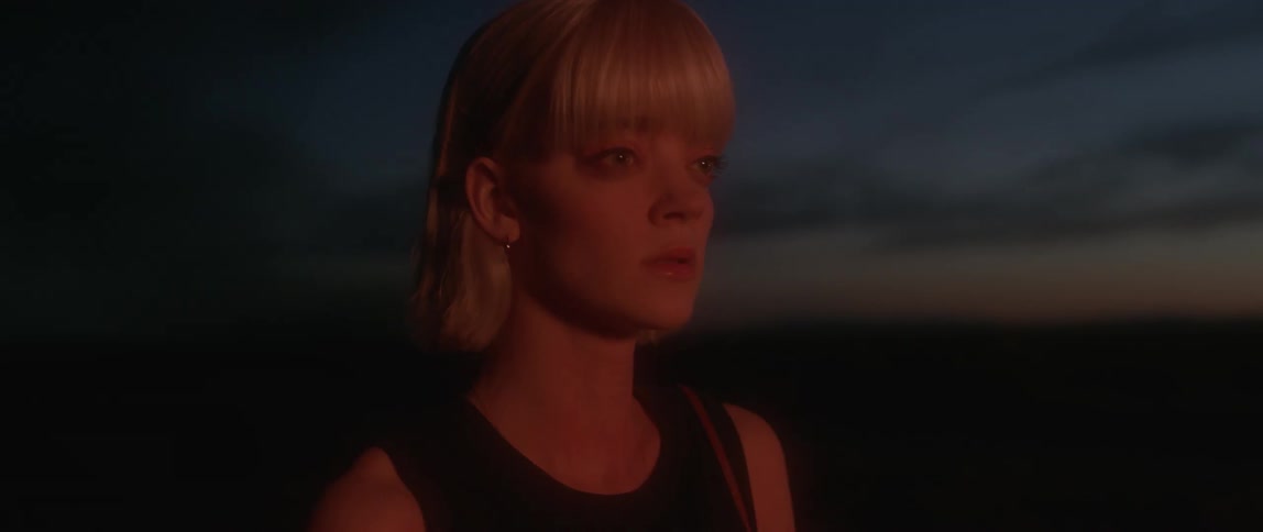 A woman looks ahead worried