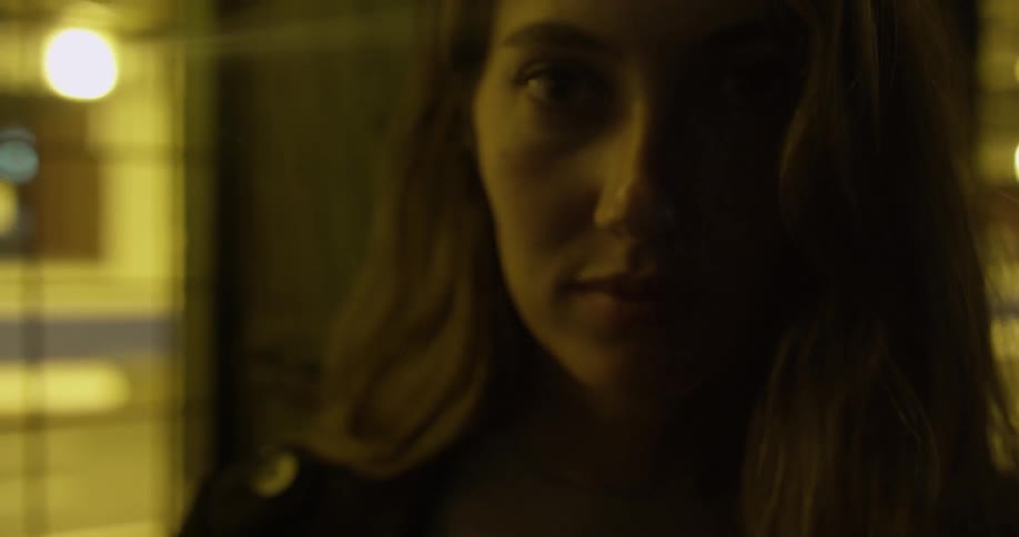 Close up of a woman's face next to a window