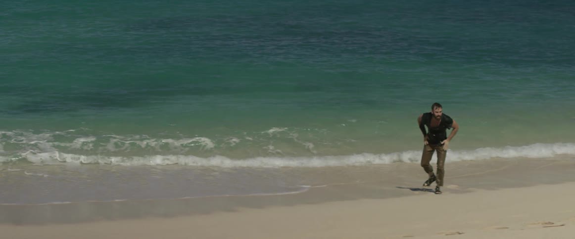 A man gets up on the beach