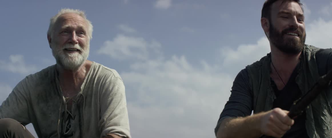 Two men laugh together while fishing