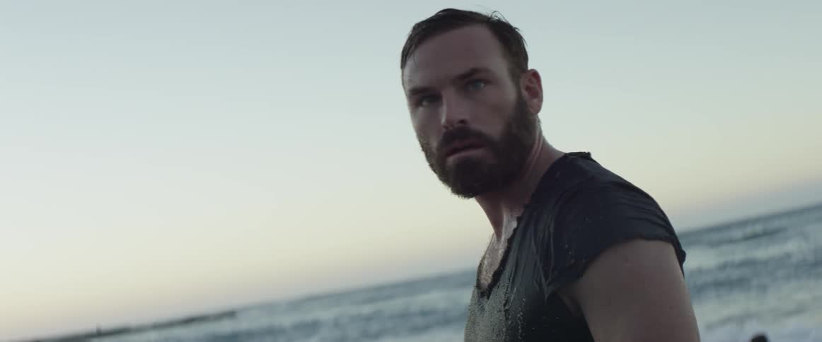 A man is standing near the beach