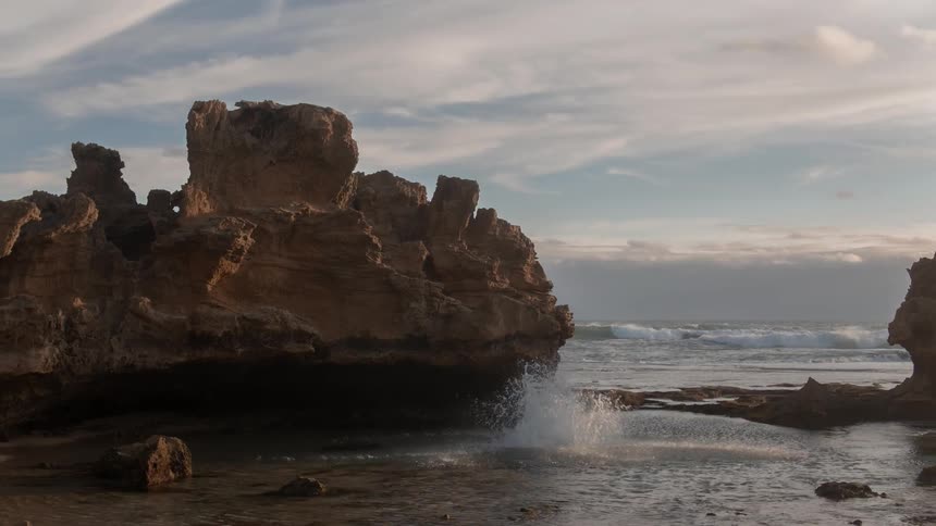 Two people jump off a cliff into the ocean below
