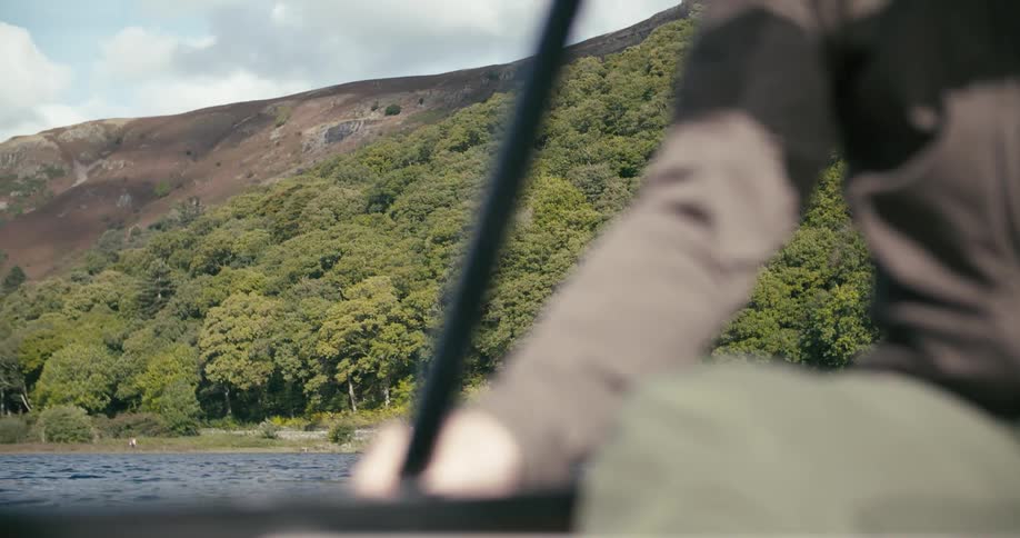 A person is rowing towards the shore