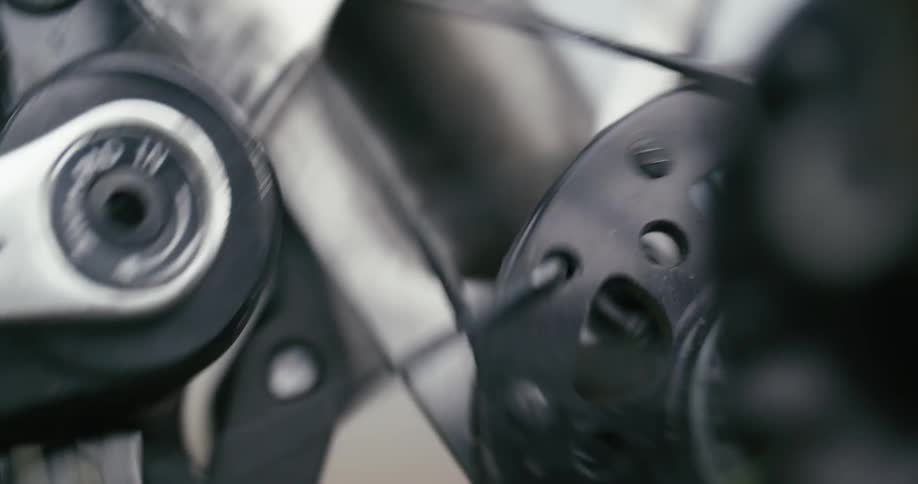 Motorcycle wheel spinning as it moves down the road