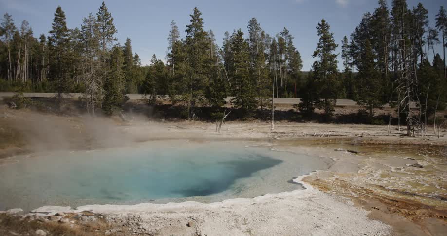Steam rises from a hot spring