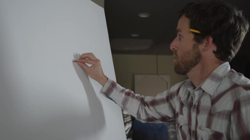 Man drawing a picture on an easel
