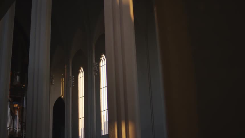 The interior of a church focusing on the columns and arched windows
