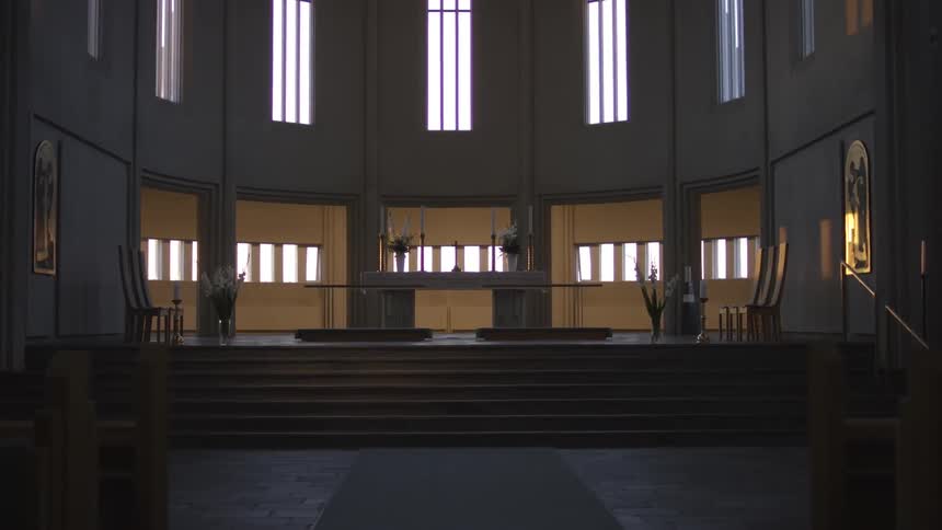 The interior sanctuary room of a worship area with many windows