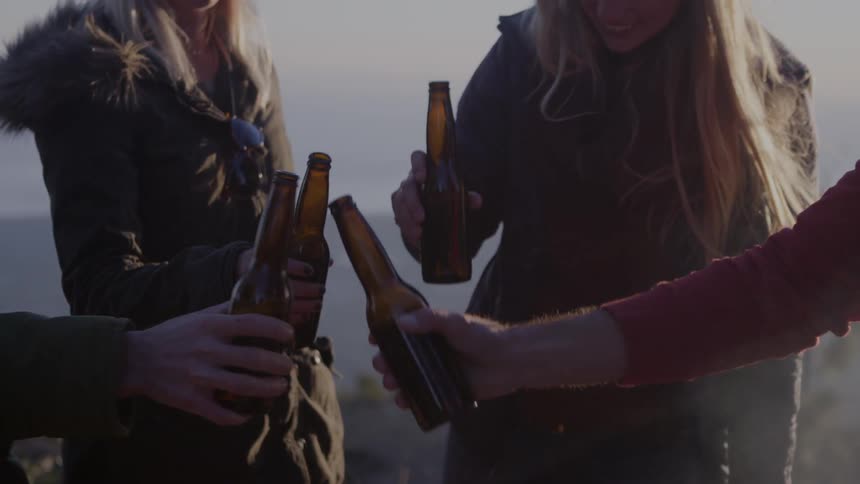 A few friends celebrating an occasion by drinking beers