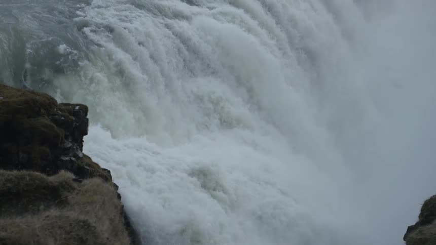 A massive waterfall flowing over a rocky precipice