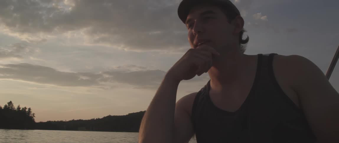 A man on a boat at sunset