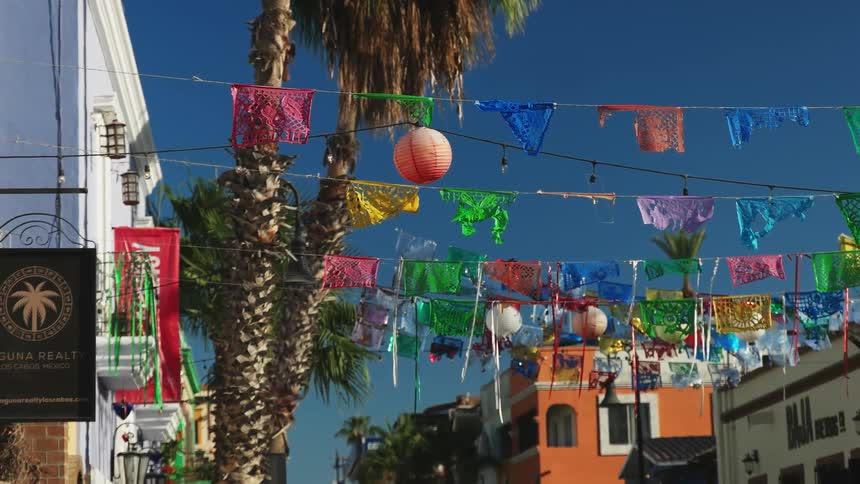 Flags and streamers swaying in the breeze in city on sunny day