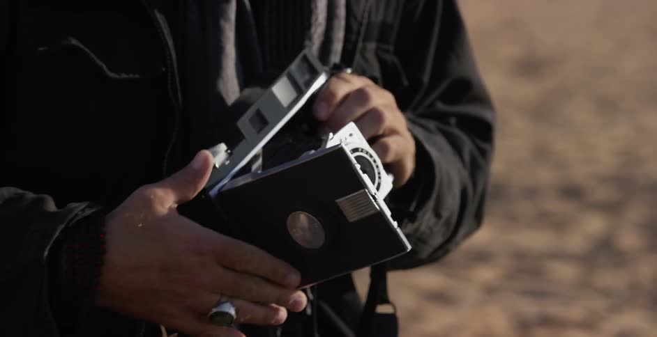 Man setting up an old fashioned camera outside