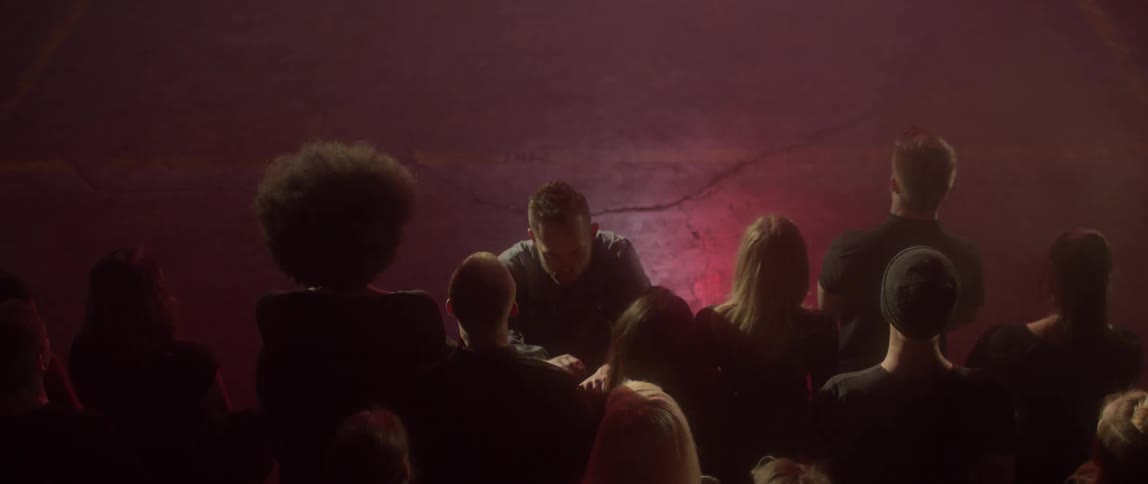 A man walks towards the crowd slowly