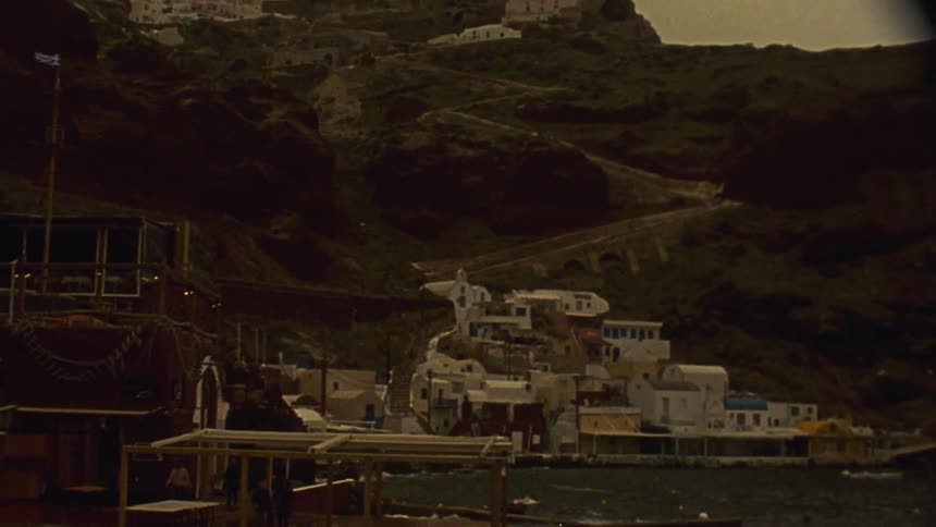 A group of buildings cling to a hillside in a fishing village