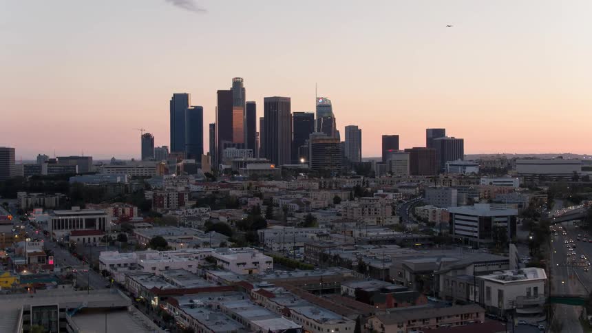 The sun is setting below the city ahead