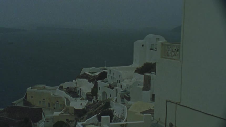 Houses line the cliffside of a coastal town