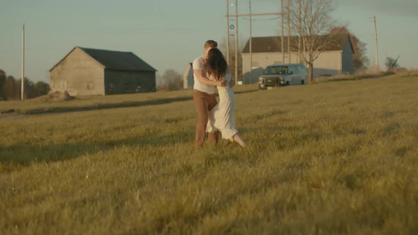 A man walks after a woman on the field