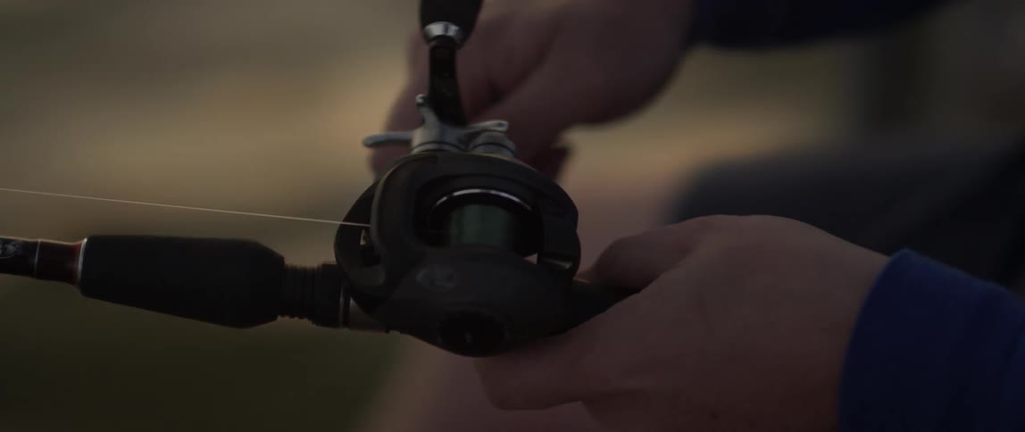 A man using a fishing wheel