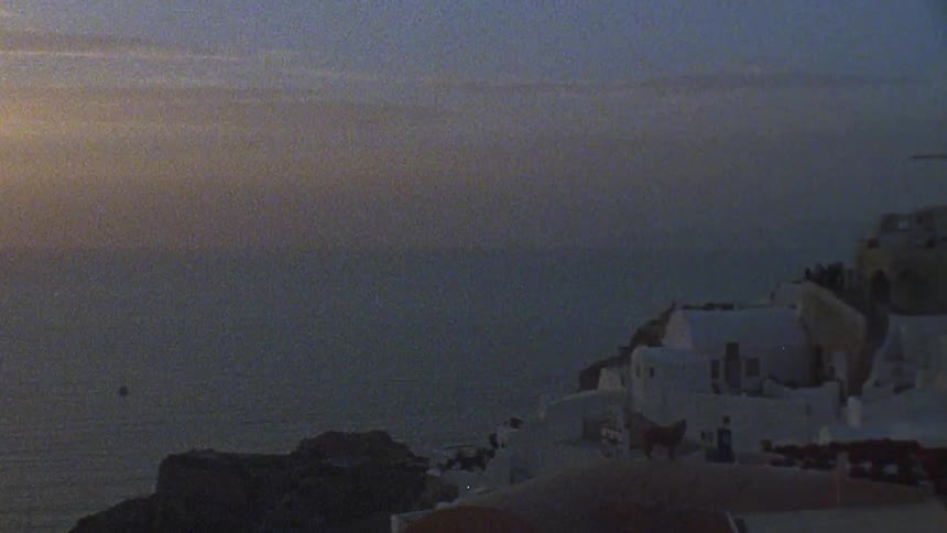 The sun is setting by the shore town