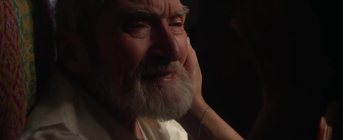 An elderly man is consoled by a woman