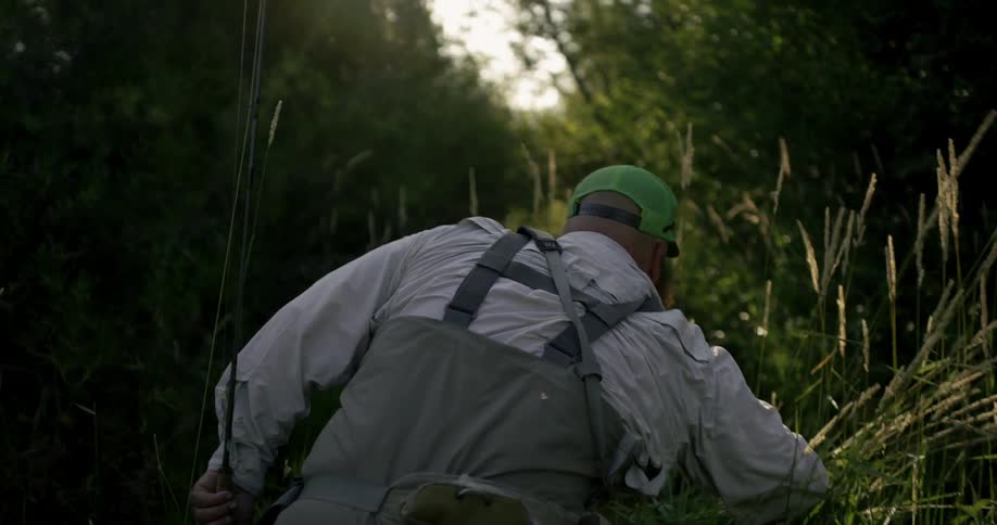 A man wades through the tall grass