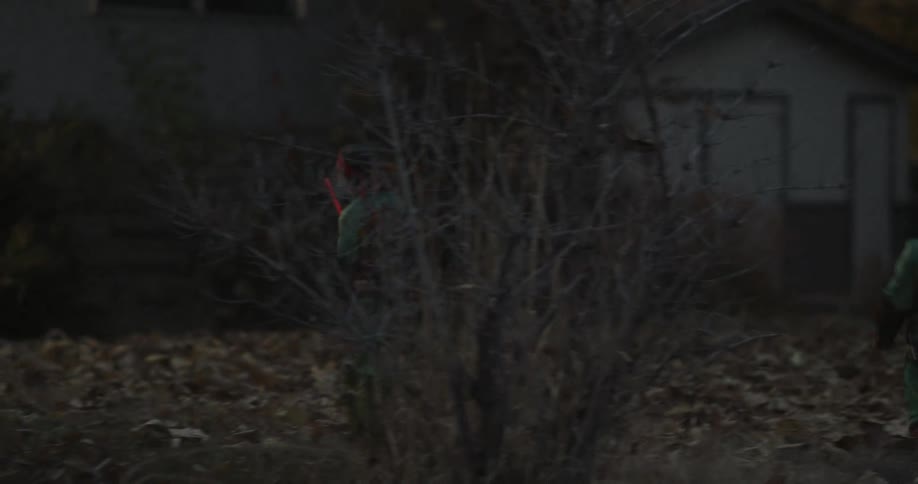 Children dressed as ninja turtles run to a house to trick or treat