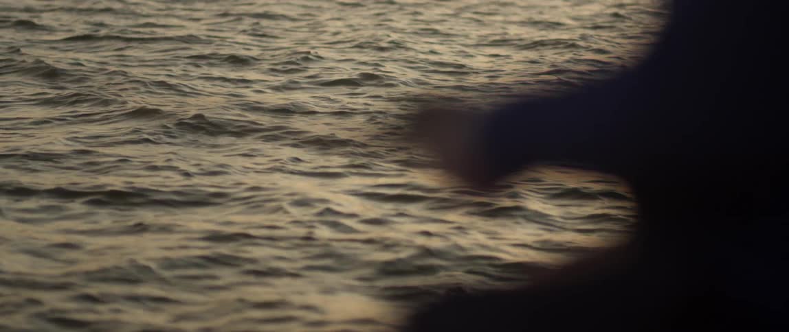 A fisherman reels in his line