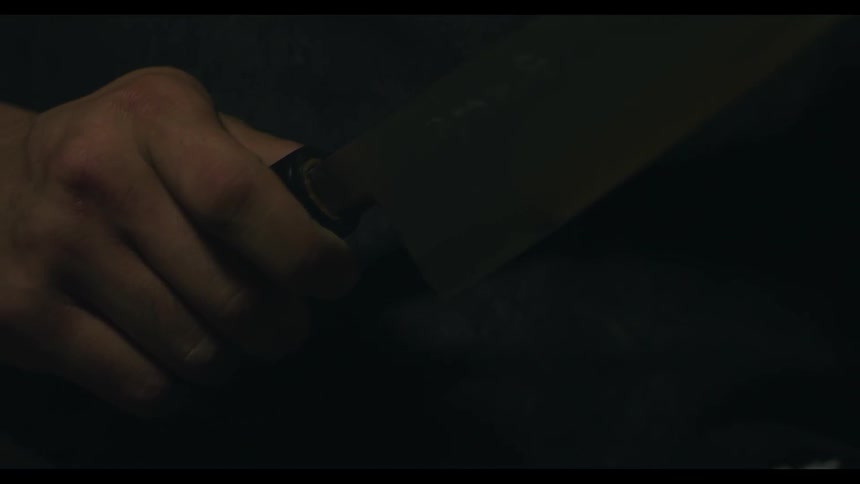 A man holds a sharp knife
