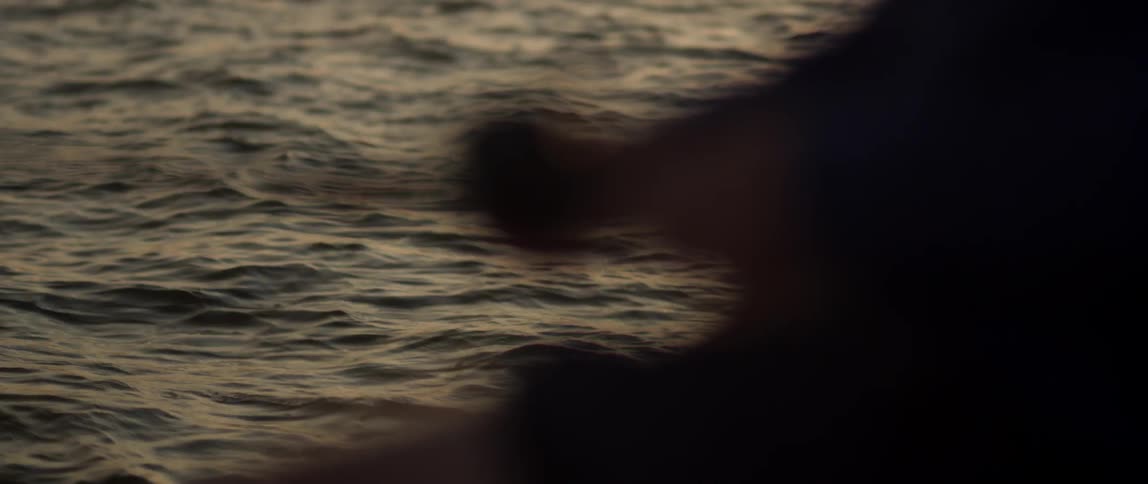 A fisherman reels his line in