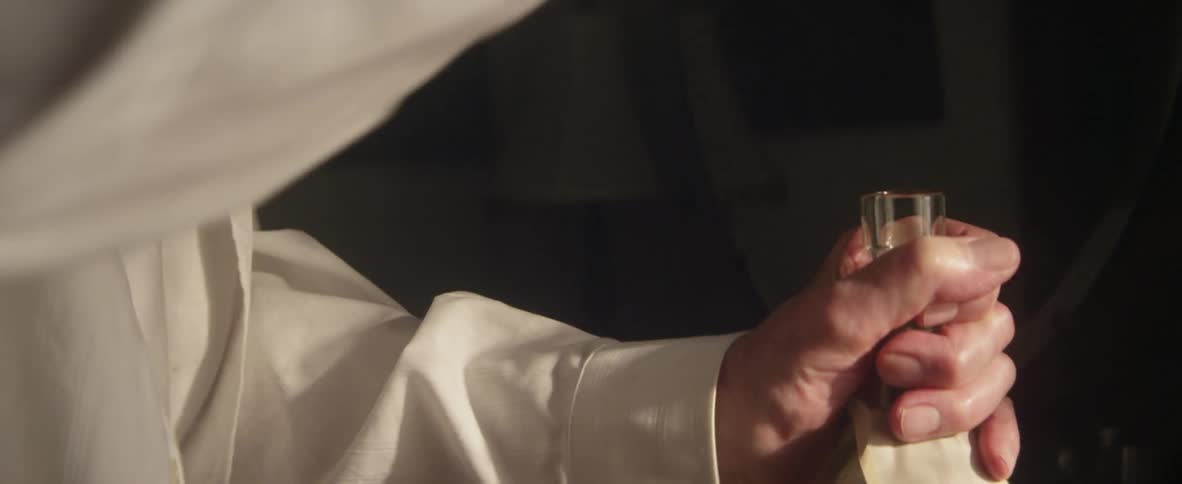 A man opens a bottle of liquor