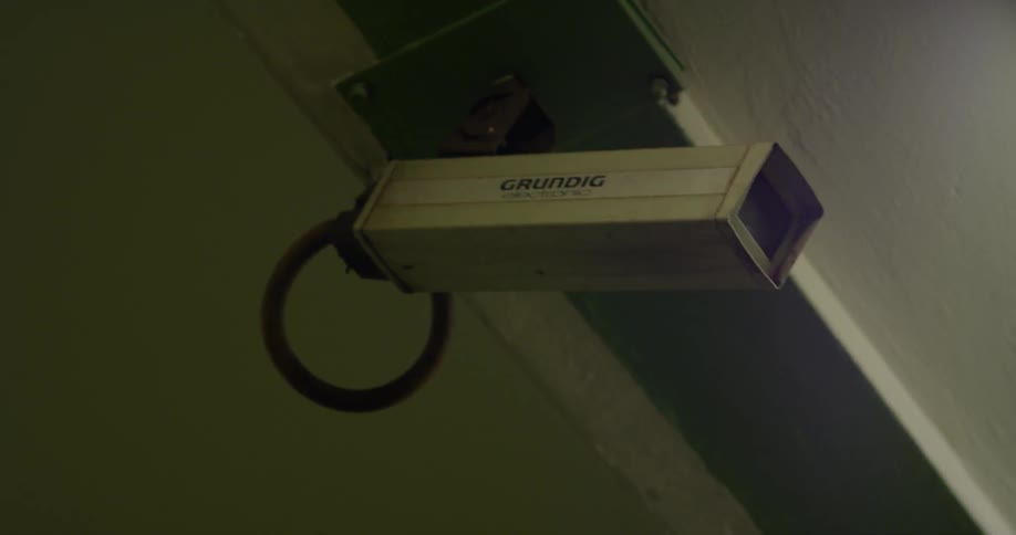 A security camera hangs from the ceiling