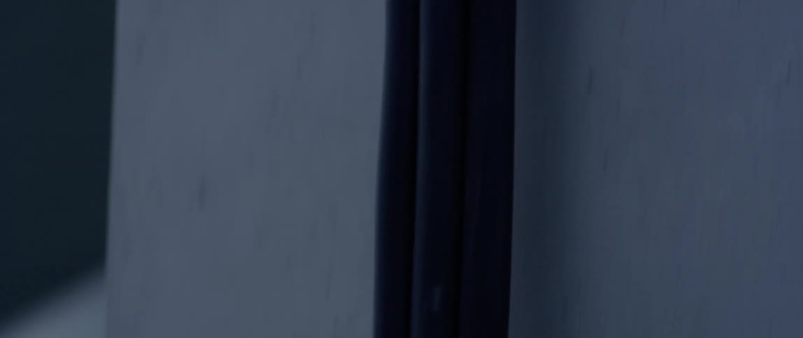 A hose travels from a house onto the ground outside