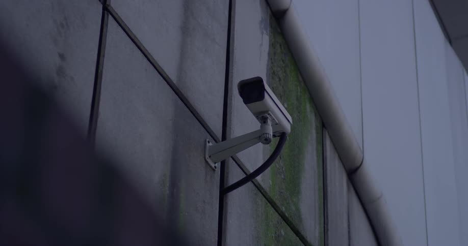 A camera is set on the side of a building